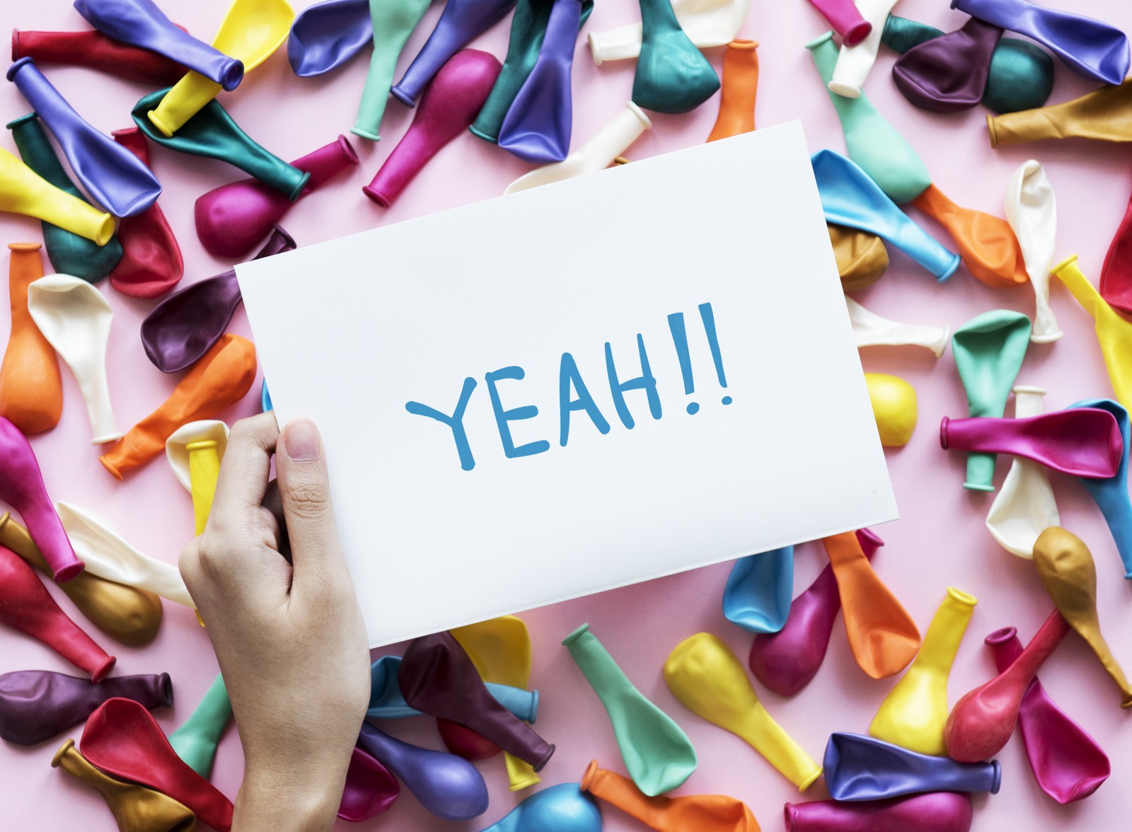 person holding Yeah!! printer paper” by rawpixel on Unsplash