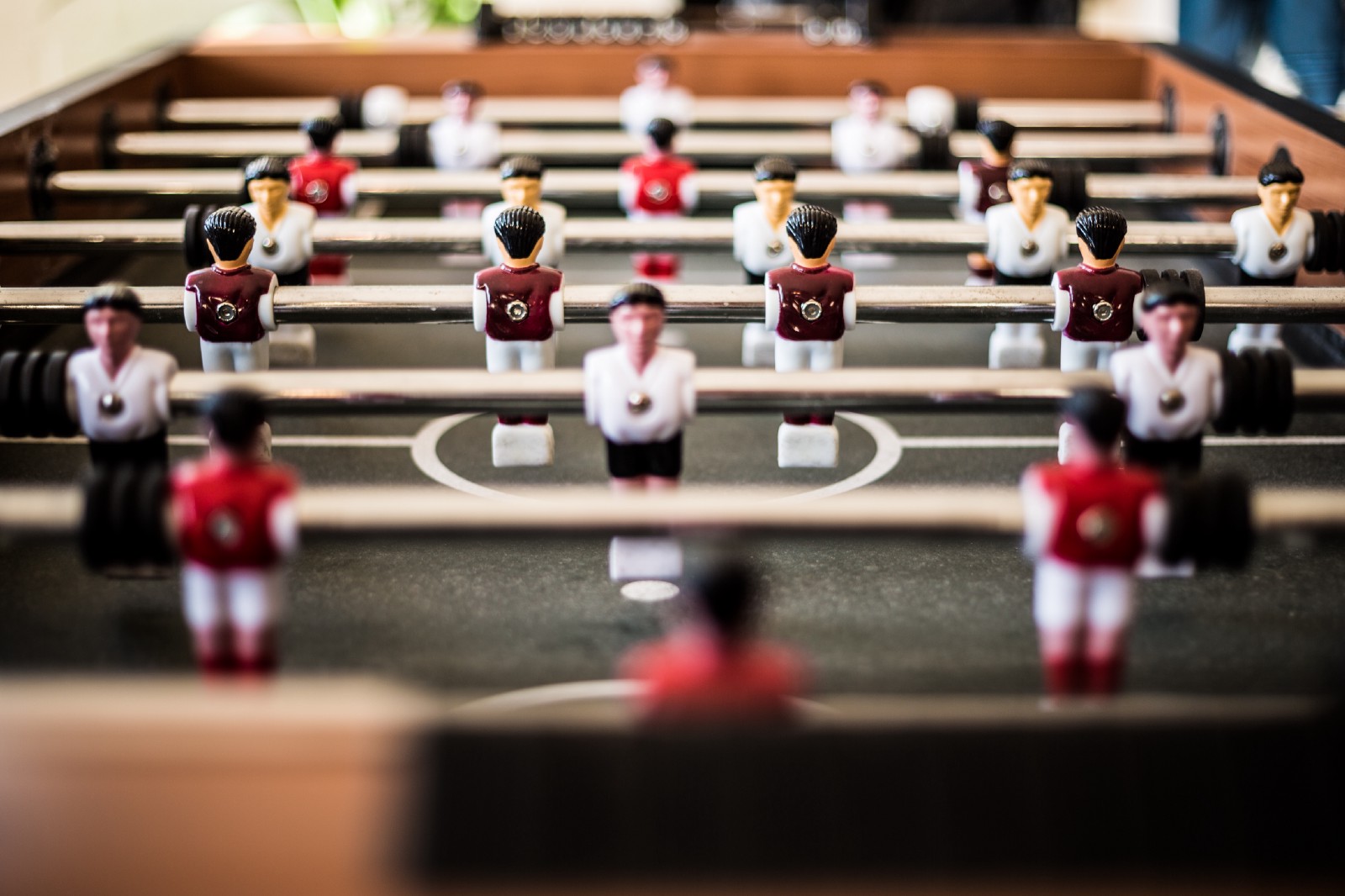 brown foosball table closeup photography” by Pascal Swier on Unsplash